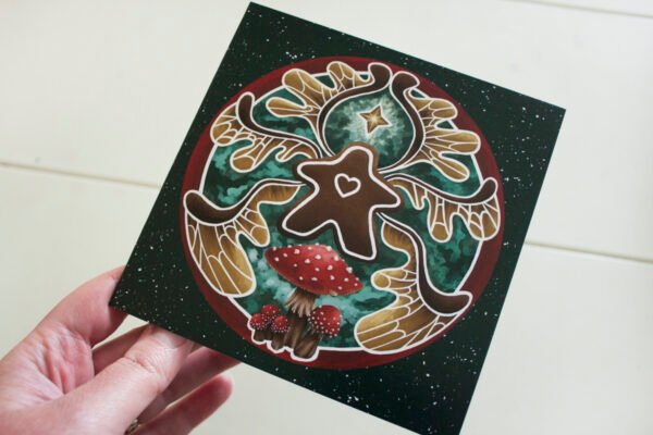 Square Christmas Card of digital painting “Gingerbread Faerie” by Imogen Smid held by the artist to demonstrate the size