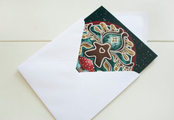 Green, red and ochre Winged Gingerbread fairy seasonal greetings card in white paper envelope which is included with card