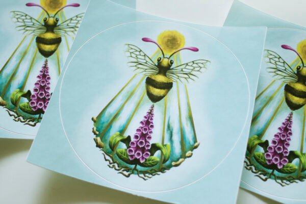 Close up of Round Sticker of Illustration “Sacro Nectare” featuring a honey bee with sun, and foxglove plant (digitalis)