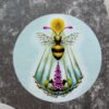 Colourful Round Sticker of the fantasy digital painting “Sacro Nectare” by Imogen Smid stuck on grey work folder