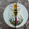 Bee and Foxglove flower sticker up close with ruler lying on it to demonstrate that the size of the sticker is approx. 94mm.