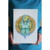 Artist holding A4 Digital Print of Illustration “Earth Diver Beetle” featuring a scarab holding an earth globe dripping water
