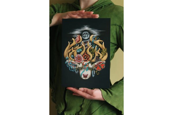 Artist holding A4 Digital Print of Illustration “The Stag’s Head” featuring four nature elements: earth, air, fire, and water