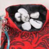Red taffeta knotwork tree pouch with black poly-satin lining, white rune stones that spell Imogen are sitting in the pouch