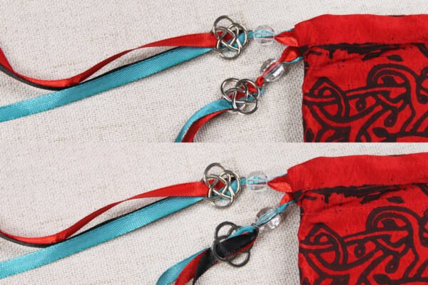 Close Up of Druid Tree Pouch showing teal, red and black ribbons, clear plastic beads and metal knotwork charms