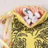 Yellow cotton knotwork tree pouch with pink poly-satin lining, white rune stones that spell Imogen are sitting in the pouch
