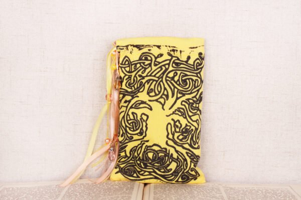 Standing yellow cotton pouch with hand printed Celtic tree pattern, printed using a hand carved lino stamp by Imogen Smid