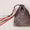 Closed Silver handprinted fabric mythology drawstring bag with Cernunnos oak leaf print with ribbons and beads splayed out