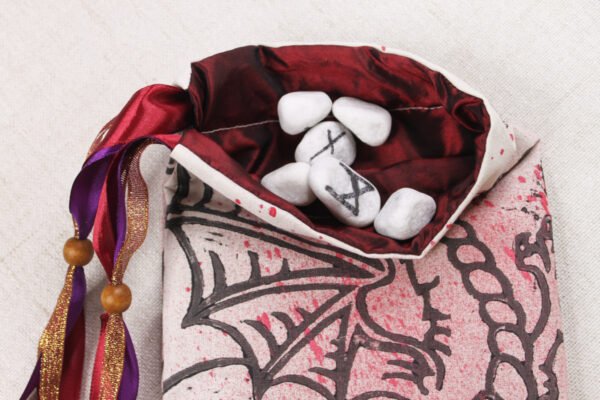 Cream Red Purple Dragon pouch with burgundy taffeta lining, white rune stones that spell Imogen are sitting in the pouch
