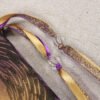 Close Up of Glastonbury Tor Pouch with gold spray showing gold and purple ribbons and clear plastic beads