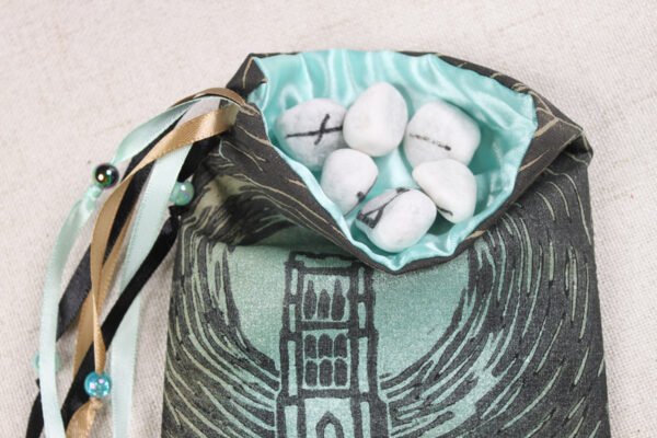 Sand cotton Glastonbury Tor pouch with mint poly-satin lining, rune stones that spell Imogen are sitting in the pouch