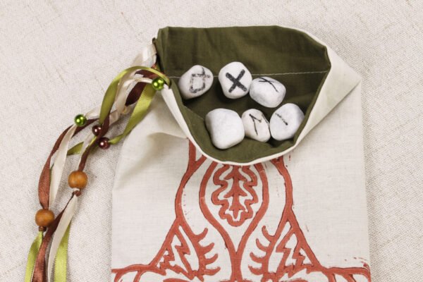 Unbleached Cotton Tanngrisnir Tanngnjóstr pouch with moss coloured cotton lining, rune stones spelling Imogen are in pouch