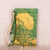 Standing yellow poly-satin pouch with hand printed Selkie pattern, printed using a hand carved lino stamp by Imogen Smid