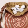 Brown poly-satin tree ring knowledge pouch with gold taffeta lining, white rune stones spelling Imogen are sitting in pouch