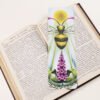Honey Bee, Apis mellifera, bookmark with yellow, blue, magenta and green colours on a black and white text page of open book