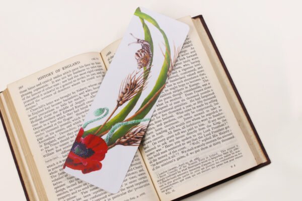 Garden Snail, Cornu aspersum, bookmark with green, red, ochre and brown colours on a black and white text page of open book