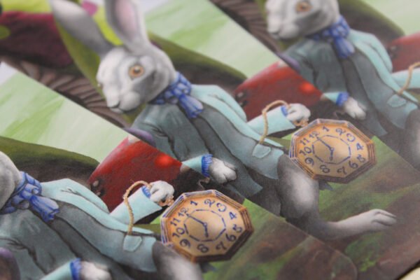 Detail of White Rabbit Bookmark showing the clothed anthropomorphic rabbit holding a large blue and gold pocket watch