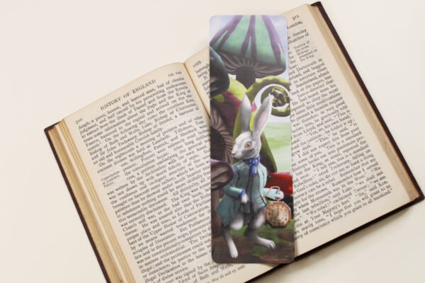 White Rabbit of Wonderland, bookmark with large magical toadstools and mushroom on a black and white text page of open book