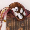 Red burgundy taffeta Bastet Cat pouch with ochre cotton lining, white rune stones that spell Imogen are sitting in the pouch