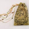 Moss Green handprinted fabric drawstring bag with Arthurian Dragon print closed with colourful ribbons and beads splayed out