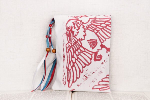 Standing white poly-satin pouch with hand printed ravens pattern, printed using hand carved lino stamps by Imogen Smid