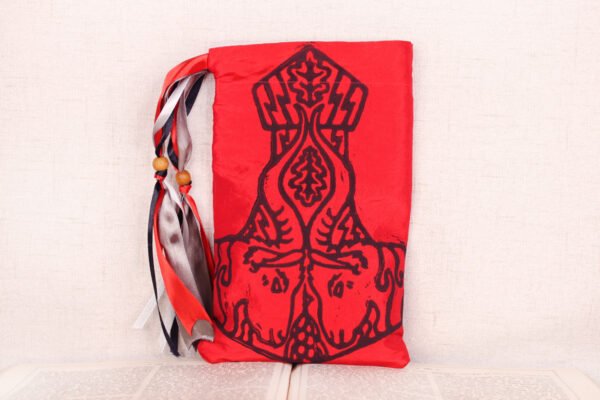 Standing red taffeta pouch with hand printed Thurisa Mjollnir pattern, printed using hand carved lino stamps by Imogen Smid