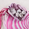 White Cotton tree ring knowledge pouch with gold taffeta lining, white rune stones spelling Imogen are sitting in pouch