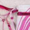 Close Up of Hypno Water Ripple Pouch showing ribbons in shades of pink, iridescent pink plastic beads and magenta sequin band