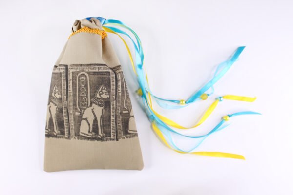 Taupe handprinted fabric drawstring bag with Cat Goddess print closed with colourful ribbons and beads splayed out