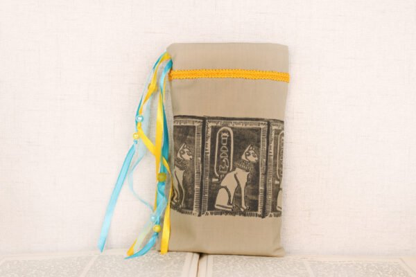 Standing sandy taupe cotton pouch with hand printed Bastet pattern, printed using a hand carved lino stamp by Imogen Smid