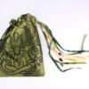 Closed green handprinted fabric mythology drawstring bag with Cernunnos oak leaf print with ribbons and beads splayed out