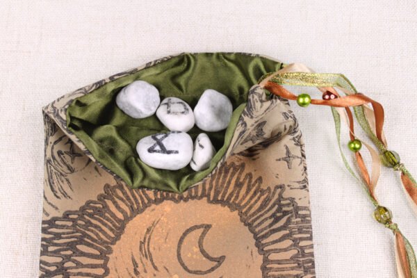 Brown Cotton Moon Gate pouch with moss green poly-satin lining, white rune stones that spell Imogen are sitting in the pouch