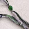 Close Up of Moon Pouch showing green, grey and silver ribbons, clear green and pearly silver plastic beads