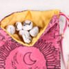 Pink Taffeta Moon Gate pouch with gold poly-satin lining, white rune stones that spell Imogen are inside the pouch