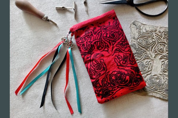 Hand printed pouch with, lino cutters, forged scissors and hand carved lino stamp which was used for printing this pouch