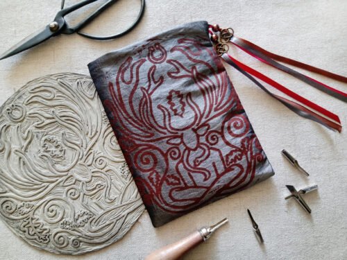 Hand printed pouch with, lino cutters, forged scissors and hand carved lino stamp which was used for printing this pouch