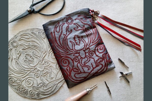 Hand printed pouch with, lino cutters, forged scissors and hand carved lino stamp which was used for printing this pouch