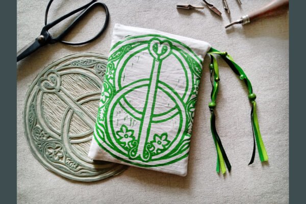 Hand printed pouch with, lino cutters, forged scissors and hand carved lino stamp which was used for printing this pouch