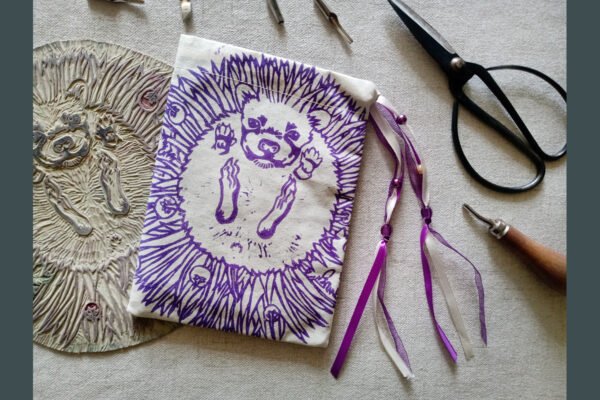 Hand printed pouch with, lino cutters, forged scissors and hand carved lino stamp which was used for printing this pouch