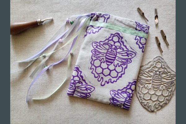 Hand printed pouch with, lino cutters and hand carved lino stamp which was used for printing this pouch