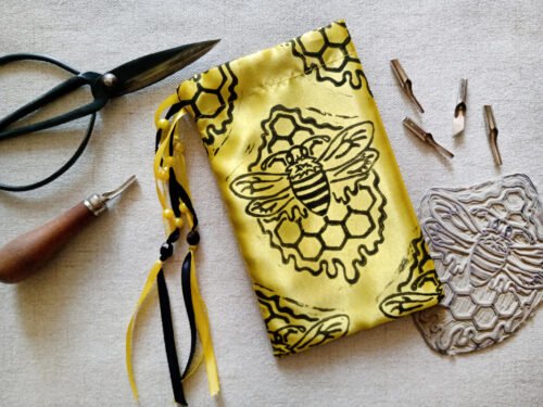 Hand printed pouch with, lino cutters, forged scissors and hand carved lino stamp which was used for printing this pouch