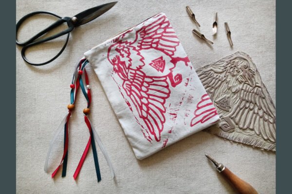 Hand printed pouch with, lino cutters, forged scissors and hand carved lino stamp which was used for printing this pouch