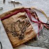 Hand printed pouch with, lino cutters, forged scissors and hand carved lino stamp which was used for printing this pouch