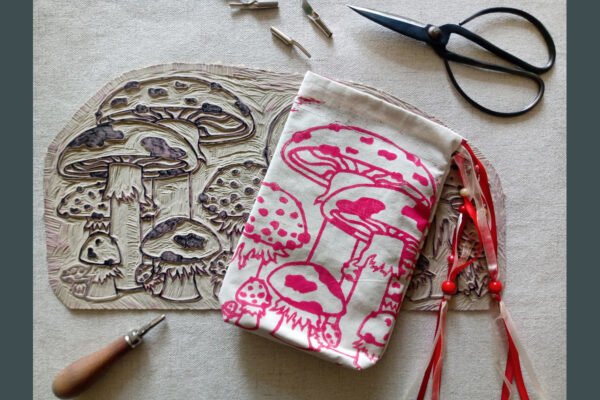 Hand printed pouch with, lino cutters, forged scissors and hand carved lino stamp which was used for printing this pouch