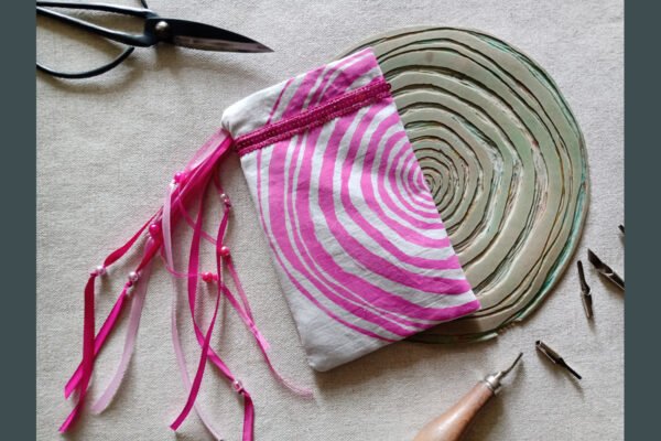 Hand printed pouch with, lino cutters, forged scissors and hand carved lino stamp which was used for printing this pouch